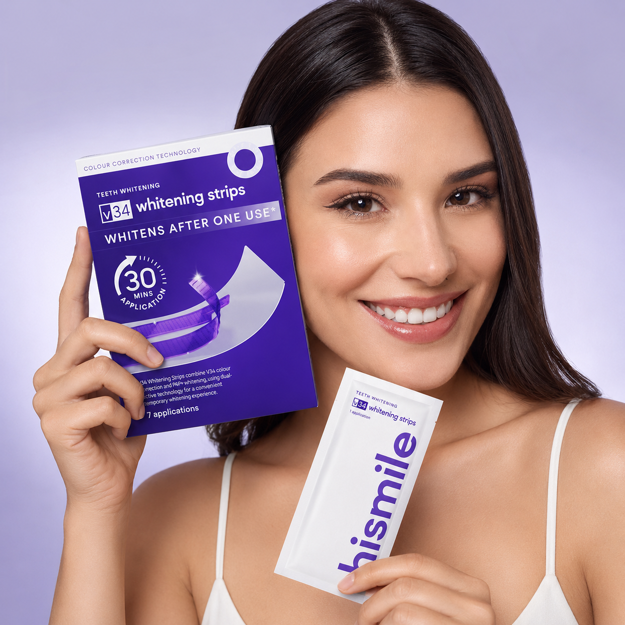 Woman holding a package of teeth whitening strips with a purple background