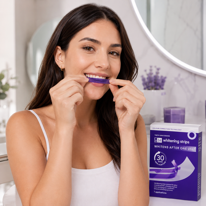 Woman using teeth whitening strips with a box in a bathroom setting