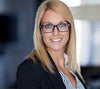 Woman wearing glasses and a striped shirt in an office setting